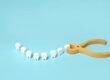 Tooth extraction with a dental instrument with forceps.
